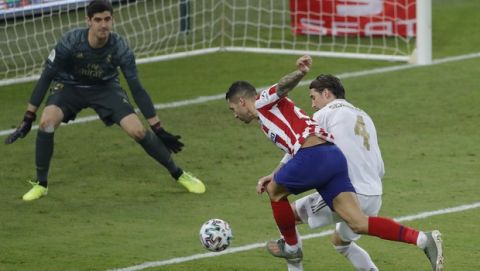 Atletico Madrid's Vitolo shoots the ball as Real Madrid's Sergio Ramos tries to stop him during the Spanish Super Cup Final soccer match between Real Madrid and Atletico Madrid at King Abdullah stadium in Jiddah, Saudi Arabia, Monday, Jan. 13, 2020. (AP Photo/Amr Nabil)