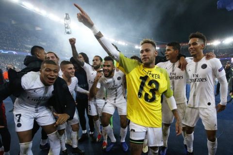 PSG players celebrate their victory, with Neymar wraring Liverpool goalkeeper Alisson' yellow jersey, after the Champions League Group C second leg soccer match between Paris Saint Germain and Liverpool at the Parc des Princes stadium in Paris, Wednesday, Nov. 28, 2018. PSG won 2-1. (AP Photo/Thibault Camus)