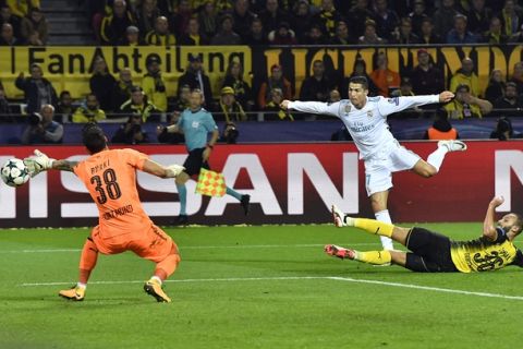 Real Madrid's Cristiano Ronaldo, center, scores his side's 3rd goal during the Champions League group H soccer match between Borussia Dortmund and Real Madrid CF in Dortmund, Germany, Tuesday, Sept. 26, 2017. (AP Photo/Martin Meissner)