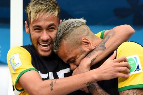 BRASILIA, BRAZIL - JULY 12:  An injured Neymar and Dani Alves of Brazil share a joke on the bench prior to the 2014 FIFA World Cup Brazil Third Place Playoff match between Brazil and the Netherlands at Estadio Nacional on July 12, 2014 in Brasilia, Brazil.  (Photo by Buda Mendes/Getty Images)