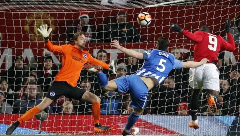 Manchester United's Romelu Lukaku, right, scores his side's opening goal during the English FA Cup quarterfinal soccer match between Manchester United and Brighton, at the Old Trafford stadium in Manchester, England, Saturday, March 17, 2018. (AP Photo/Frank Augstein)