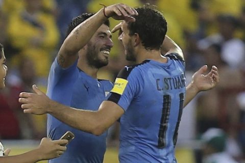 Uruguay's Luis Suarez, left, embraces Christian Stuani, right, at the end of a 2018 World Cup qualifying soccer match against Colombia in Barranquilla, Colombia, Tuesday, Oct. 11, 2016. The match ended in a 2-2 draw. (AP Photo/Fernando Vergara)