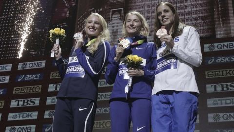 Medalists in the women's pole vault Anzhelika Sidorova, who participates as a neutral athlete, gold, center, Sandi Morris of the United States, silver, left, and Katerina Stefanidi of Greece, bronze, pose during the medal ceremony at the World Athletics Championships in Doha, Qatar, Monday, Sept. 30, 2019. (AP Photo/Nariman El-Mofty)