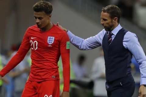 England head coach Gareth Southgate escorts Dele Alli after replacing him with Ruben Loftus-Cheek during the group G match against Tunisia at the 2018 soccer World Cup in the Volgograd Arena in Volgograd, Russia, Monday, June 18, 2018. (AP Photo/Alastair Grant)