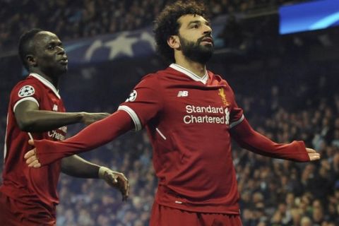 Liverpool's Mohamed Salah, right, celebrates scoring his side's first goal with Liverpool's Sadio Mane during the Champions League quarterfinal second leg soccer match between Manchester City and Liverpool at Etihad stadium in Manchester, England, Tuesday, April 10, 2018. (AP Photo/Rui Vieira)