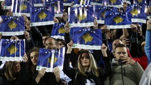 Fans hold up placards with the Kosovo flags before the Euro 2020 group A qualifying soccer match between Kosovo and England at Fadil Vokrri stadium in Pristina, Kosovo, Sunday, Nov. 17, 2019. (AP Photo/Boris Grdanoski)