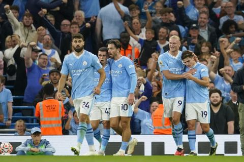 Manchester City's Julian Alvarez, right, celebrates with teammates after scoring his side's opening goal during the English Premier League soccer match between Manchester City and Newcastle at the Etihad stadium in Manchester, England, Saturday, Aug. 19, 2023. (AP Photo/Dave Thompson)