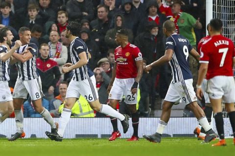 West Bromwich Albion's Jay Rodriguez, left, celebrates scoring his side's first goal of the game against Manchester United during the English Premier League soccer match at Old Trafford, Manchester, England, Sunday April 15, 2018. (Nick Potts/PA via AP)