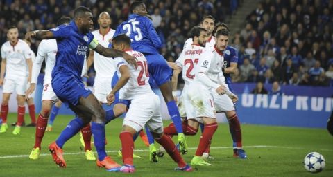 Leicester's Wes Morgan, left, scores a goal during the Champions League round of 16 second leg soccer match between Leicester City and Sevilla at the King Power Stadium in Leicester, England, Tuesday, March 14, 2017. (AP Photo/Rui Vieira)