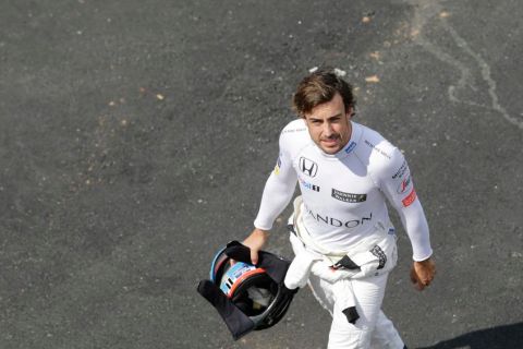 McLaren driver Fernando Alonso, of Spain, walks back to his pits after failing to complete a lap during the second free practice at the Interlagos race track in Sao Paulo, Brazil, Friday, Nov. 11, 2016. Brazil will stage the Formula One Grand Prix's penultimate race of the season on Sunday. (AP Photo/Nelson Antoine)