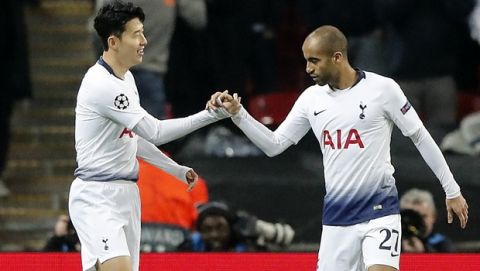 Tottenham midfielder Heung-Min Son, left, celebrates his opening goal with Tottenham midfielder Lucas Moura, right, during the Champions League round of 16, first leg, soccer match between Tottenham Hotspur and Borussia Dortmund at Wembley stadium in London, England, Wednesday, Feb. 13, 2019. (AP Photo/Frank Augstein)