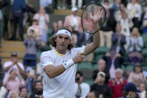 Greece's Stefanos Tsitsipas celebrates after defeating Switzerland's Alexander Ritschard in a singles tennis match on day two of the Wimbledon tennis championships in London, Tuesday, June 28, 2022. (AP Photo/Alastair Grant)