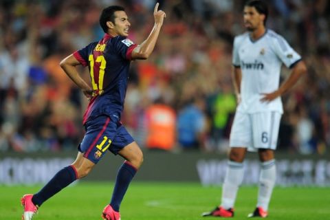 Barcelona's forward Pedro Rodriguez celebrates after scoring a goal during the first leg of the Spanish Supercup football match FC Barcelona vs Real Madrid CF on August 23, 2012 at the Camp Nou stadium in Barcelona.   AFP PHOTO/ LLUIS GENE        (Photo credit should read LLUIS GENE/AFP/GettyImages)