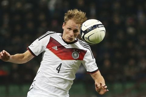 Germany defender Benedikt Howedes stops the ball during a friendly soccer match between Italy and Germany at the San Siro  stadium in Milan, Italy, Friday, Nov. 15, 2013. (AP Photo/Antonio Calanni)