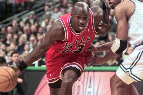 FILE - In this Oct. 31, 1997, file photo Chicago Bulls guard Michael Jordan (23) drives past Boston Celtics Ron Mercer (5) during an NBA basketball game in Boston.  A Bismarck, N.D., man who used to own McDonald's restaurants is about $10,000 richer after selling a 20-year-old container of McJordan barbecue sauce Monday, Oct. 15, 2012, to a buyer in Chicago. The sauce was used on McJordan Burgers, named for basketball icon in limited markets for a short time in the 1990s, when Jordan led the Chicago Bulls to six NBA championships. (AP Photo/Stephan Savoia, file)