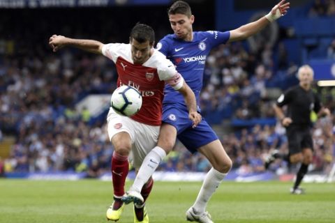 Chelsea's Jorginho fights for the ball with Arsenal's Henrikh Mkhitaryan, left, during the English Premier League soccer match between Chelsea and Arsenal at Stamford bridge stadium in London, Saturday, Aug. 18, 2018. (AP Photo/Tim Ireland)