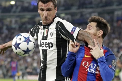 Juventus's Mario Mandzukic, left, and Barcelona's Lionel Messi vie for the ball during a Champions League, quarterfinal, first-leg soccer match between Juventus and Barcelona, at the Juventus Stadium in Turin, Italy, Tuesday, April 11, 2017. (AP Photo/Antonio Calanni)