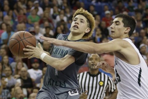 Chino Hills' Lamelo Ball, left, goes to the basket against De La Salle's Jordan Ratinho during the second half of the CIF boys' Open Division high school basketball championship game Saturday, March 26, 2016, in Sacramento, Calif. Chino Hills won 70-50. (AP Photo/Rich Pedroncelli)