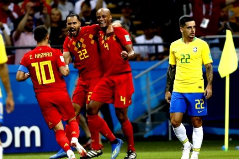 Belgium's Eden Hazard, Nacer Chadli and Vincent Kompany, from left, celebrate their first goal after Brazil's Fernandinho scored an own goal during the quarterfinal match between Brazil and Belgium at the 2018 soccer World Cup in the Kazan Arena, in Kazan, Russia, Friday, July 6, 2018. (AP Photo/Francisco Seco)