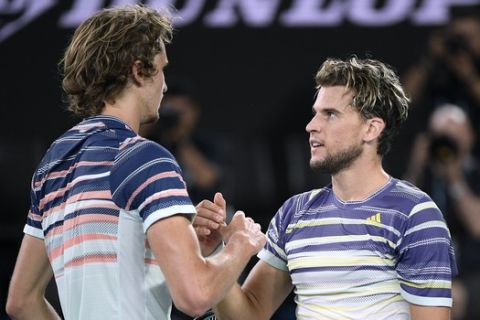 Austria's Dominic Thiem, right, is congratulated by Germany's Alexander Zverev after winning their semifinal match at the Australian Open tennis championship in Melbourne, Australia, Friday, Jan. 31, 2020. (AP Photo/Andy Brownbill)