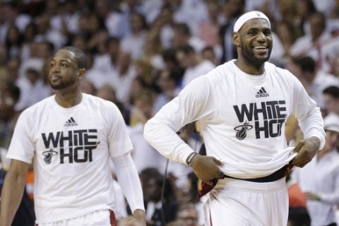 Miami Heat forward LeBron James, right, and guard Dwyane Wade smile during the second half Game 6 in the NBA basketball playoffs Eastern Conference finals against the Indiana Pacers, Friday, May 30, 2014, in Miami. The Miami Heat defeated the Indiana Pacers 117-92 to advance to the NBA Finals. (AP Photo/Lynne Sladky)
