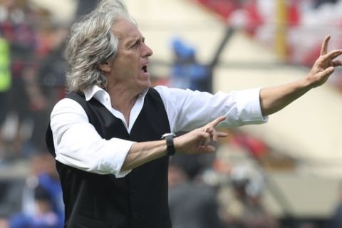 Jorge Jesus, coach of Brazil's Flamengo, gives instructions to his players during the Copa Libertadores final soccer match against Argentina's River Plate at the Monumental stadium in Lima, Peru, Saturday, Nov. 23, 2019. (AP Photo/Martin Mejia)