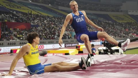 Armand Duplantis, left, of Sweden, and Sam Kendricks, of the United States, jump on the landing pad after the the men's pole vault final at the World Athletics Championships in Doha, Qatar, Tuesday, Oct. 1, 2019. (AP Photo/Hassan Ammar)