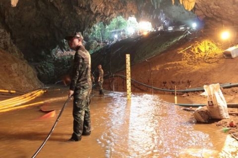 In this undated photo released by Royal Thai Navy on Saturday, July 7, 2018, Thai rescue teams arrange water pumping system at the entrance to a flooded cave complex where 12 boys and their soccer coach have been trapped since June 23, in Mae Sai, Chiang Rai province, northern Thailand. The local governor in charge of the mission to rescue them said Saturday that cooperating weather and falling water levels over the last few days had created appropriate conditions for evacuation, but that they won't last if it rains again.. (Royal Thai Navy via AP)