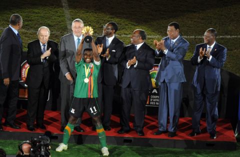 Zambian team captain Christopher Katongo (Bottom L) celebrates his team's victory as he raises the African Cup of Nations trophy during an awards ceremony at the end of the Africa Cup of Nations final football match between Ivory Coast and Zambia, at the Stade de l'Amitie in Libreville, on February 12, 2012, as FIFA President Sepp Blatter (2nd L),  Equatorial Guinea President Teodoro Obiang Nguema Mbasogo (C), Gabon President Ali Ondimba Bongo (3rd R), Benin President Yayi Boni (2nd R), and Ivory Coast President Alassane Dramane Ouattara (R) look on. Zambia won the match during the final penalty shootout AFP PHOTO / PIUS UTOMI EKPEI (Photo credit should read PIUS UTOMI EKPEI/AFP/Getty Images)