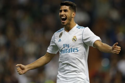 Real Madrid's Marco Asensio celebrates after scoring his side's second goal against Eibar during the Spanish La Liga soccer match between Real Madrid and Eibar at the Santiago Bernabeu stadium in Madrid, Sunday, Oct. 22, 2017. (AP Photo/Francisco Seco)