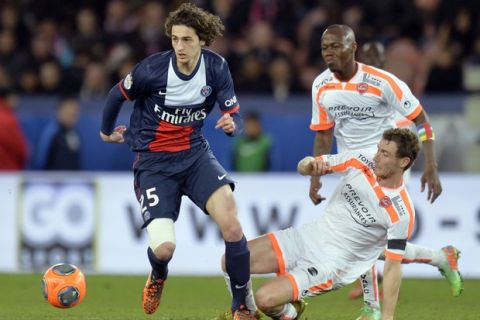 Paris' French midfielder Adrien Rabiot (L) vies for the ball with Valenciennes' French defender David Ducourtioux (R) during the French L1 football match between Paris Saint-Germain (PSG) and Valenciennes on February 14, 2014 at the Parc des Princes stadium in Paris.  AFP PHOTO / MIGUEL MEDINA        (Photo credit should read MIGUEL MEDINA/AFP/Getty Images)