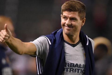 FILE - In this Feb. 9, 2016, file photo, Los Angeles Galaxy midfielder Steven Gerrard, gestures to fans after a soccer match against Club Tijuana, in Carson, Calif. Gerrard is returning to Liverpool, England, it was announced Friday, Jan. 20, 2017, to take up a position in the team's youth academy, starting in February. (AP Photo/Mark J. Terrill, File)