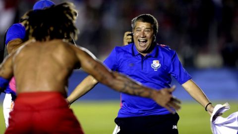 FILE - In this Tuesday, Oct. 10, 2017 filer, Panama's coach Hernan Dario Gomez, from Colombia, celebrates with his player Roman Torres who scored his team's second goal, after a 2018 Russia World Cup qualifying soccer match against Costa Rica in Panama City. (AP Photo/Arnulfo Franco, File)