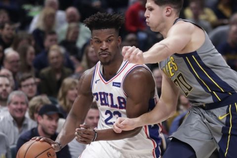 Philadelphia 76ers guard Jimmy Butler (23) drives on Indiana Pacers forward Doug McDermott (20) during the first half of an NBA basketball game in Indianapolis, Thursday, Jan. 17, 2019. (AP Photo/Michael Conroy)