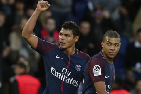 PSG's Thiago Silva, left, celebrates with Kylian Mbappe after scoring during the French League One soccer match between Paris Saint-Germain and Metz at the Parc des Princes Stadium, in Paris, France, Saturday, March 10, 2018. (AP Photo/Thibault Camus)