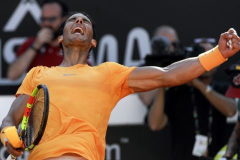 Spain's Rafael Nadal celebrates after winning his semifinal match against Serbia's Novak Djokovic at the Italian Open tennis tournament, in Rome, Saturday, May 19, 2018. Rafael Nadal was challenged in the first set by Novak Djokovic before pulling away for a 7-6 (4), 6-3 win to reach the Italian Open final on Saturday. (AP Photo/Gregorio Borgia)