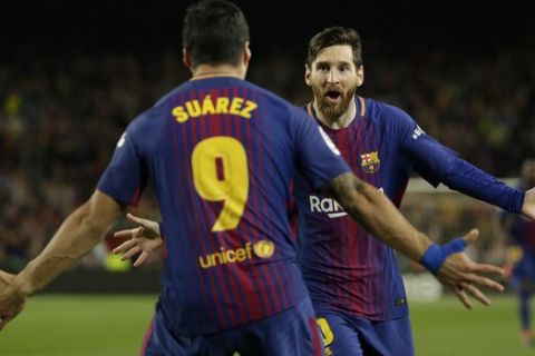 Barcelona's Lionel Messi, rear, celebrates with Barcelona's Luis Suarez after scoring his side's second goal during a Spanish La Liga soccer match between Barcelona and Real Madrid, dubbed 'El Clasico', at the Camp Nou stadium in Barcelona, Spain, Sunday, May 6, 2018. (AP Photo/Emilio Morenatti)