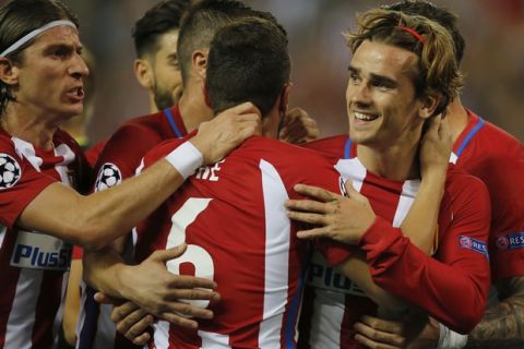 Atletico's Antoine Griezmann, right, celebrates with teammates after scoring from the penalty spot the opening goal of the game during the Champions League quarterfinal first leg soccer match between Atletico Madrid and Leicester City at the Vicente Calderon stadium in Madrid, Spain, Wednesday, April 12, 2017. (AP Photo/Paul White)