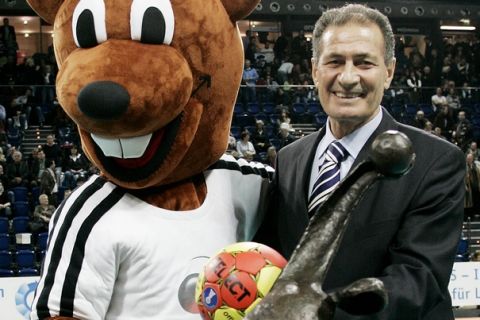 Egypt's Hassan Mustafa Mussa, President of the International Handball Federation (IHF) displays with the championships' mascot "Hanniball" the trophy at the Ostseehalle in Kiel, northern Germany, on Wednesday, Dec. 13, 2006. The Handball World Championships will be held from Jan. 19 until Feb. 4, 2007 in Germany. (AP Photo/Heribert Proepper)