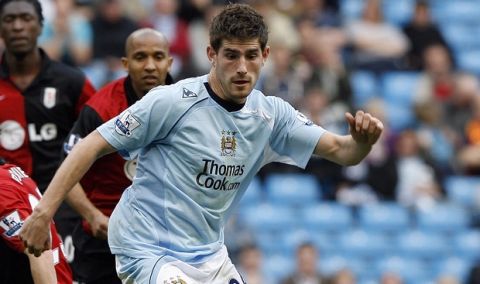 FILE - This is a Sunday, April 12, 2009 file photo of former  Manchester City's Ched Evans, right, a s he  evades Fulham's Simon Davies, left, during their English Premier League soccer match at the City of Manchester Stadium, Manchester, England. Ched Evans, a Wales international who has played for Manchester City and Sheffield United, appeared at a court in Cardiff on Friday  May 27, 2016 and pleaded not guilty to raping a woman at a hotel in May 2011. He has already served half of a five-year sentence, before being released from prison and getting the conviction overturned following an appeal.  (AP Photo/Paul Thomas, File)
