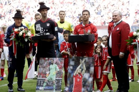 Bayern's assistant coach Hermann Gerland, from left, goalkeeper Tom Starke and Xabi Alonso stand on the pitch besides Bayern president Uli Hoeness during their farewell celebration prior to the German first division Bundesliga soccer match between FC Bayern Munich and SC Freiburg at the Allianz Arena stadium in Munich, Germany, Saturday, May 20, 2017. (AP Photo/Matthias Schrader)