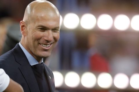 Real Madrid coach Zinedine Zidane smiles after winning the Champions League Final soccer match between Real Madrid and Liverpool at the Olimpiyskiy Stadium in Kiev, Ukraine, Saturday, May 26, 2018. (AP Photo/Efrem Lukatsky)