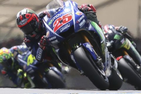 MotoGP rider Maverick Vinales of Spain steers his motorcycle as he is followed by Johann Zarco of France and Valentino Rossi of Italy during the French Grand Prix's race, in Le Mans, western France, Sunday, May 21, 2017. (AP Photo/David Vincent)