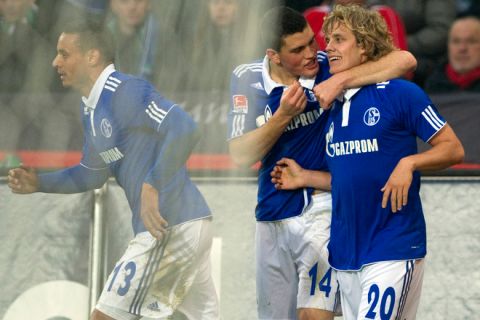 Schalke's Finnish forward Teemu Pukki (R) celebtrates scoring with teammates Greek defender Kyriakos Papadopoulos (C) and US midfielder Jermaine Jones during the German first division Bundesliga football match Hannover 96 vs Schalke 04 in the northern German city of Hanover on November 6, 2011. AFP PHOTO / ODD ANDERSEN

RESTRICTIONS / EMBARGO - DFL LIMITS THE USE OF IMAGES ON THE INTERNET TO 15 PICTURES (NO VIDEO-LIKE SEQUENCES) DURING THE MATCH AND PROHIBITS MOBILE (MMS) USE DURING AND FURTHER TWO HOURS AFTER THE MATCH: FOR MORE INFORMATION CONTACT DFL. (Photo credit should read ODD ANDERSEN/AFP/Getty Images)