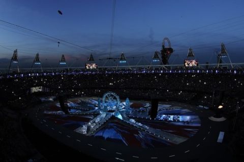 Fans take pictures in the Olympic Stadium before the start of the Closing Ceremony at the 2012 Summer Olympics, Sunday, Aug. 12, 2012, in London. (AP Photo/Morry Gash)