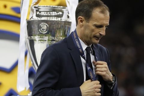 Juventus head coach Massimiliano Allegri gestures after receiving the medal after the Champions League soccer final between Juventus and Real Madrid at the Millennium Stadium in Cardiff, Wales, Saturday, June 3, 2017. (AP Photo/Kirsty Wigglesworth)
