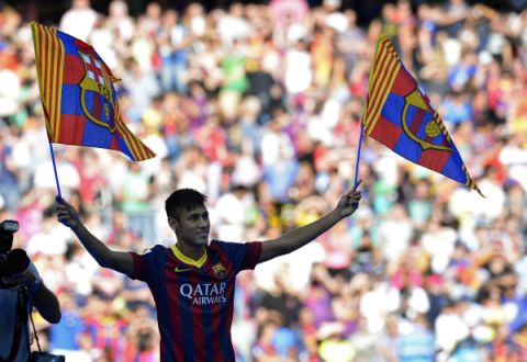 FC Barcelona's new player Brazilian Neymar da Silva Santos Junior brandishes two flags of his new club during his presentation at Camp Nou stadium in Barcelona, on June 3, 2013. Santos and Brazil star Neymar signed a five-year contract with Spanish giants Barcelona. AFP PHOTO/ LLUIS GENE