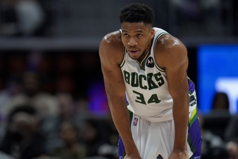 Milwaukee Bucks forward Giannis Antetokounmpo plays against the Detroit Pistons in the first half of an NBA basketball game in Detroit, Friday, April 8, 2022. (AP Photo/Paul Sancya)
