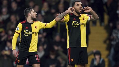 Watford's Troy Deeney, right, celebrates with Kiko Femenia after scoring against Aston Villa during the English Premier League soccer match at Vicarage Road, Watford, England, Saturday Dec. 28, 2019. (Tess Derry/PA via AP)