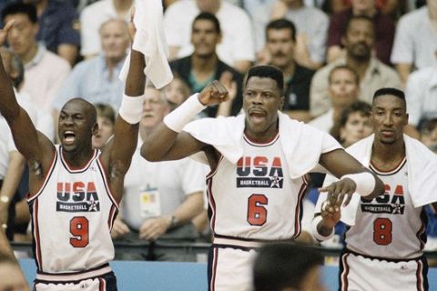USA's Michael Jordan (9), Patrick Ewing (6) and Scottie Pippen (8) cheer on teammates during gold medal basketball game against Croatia in Barcelona Saturday. (AP Photo/John Gaps)